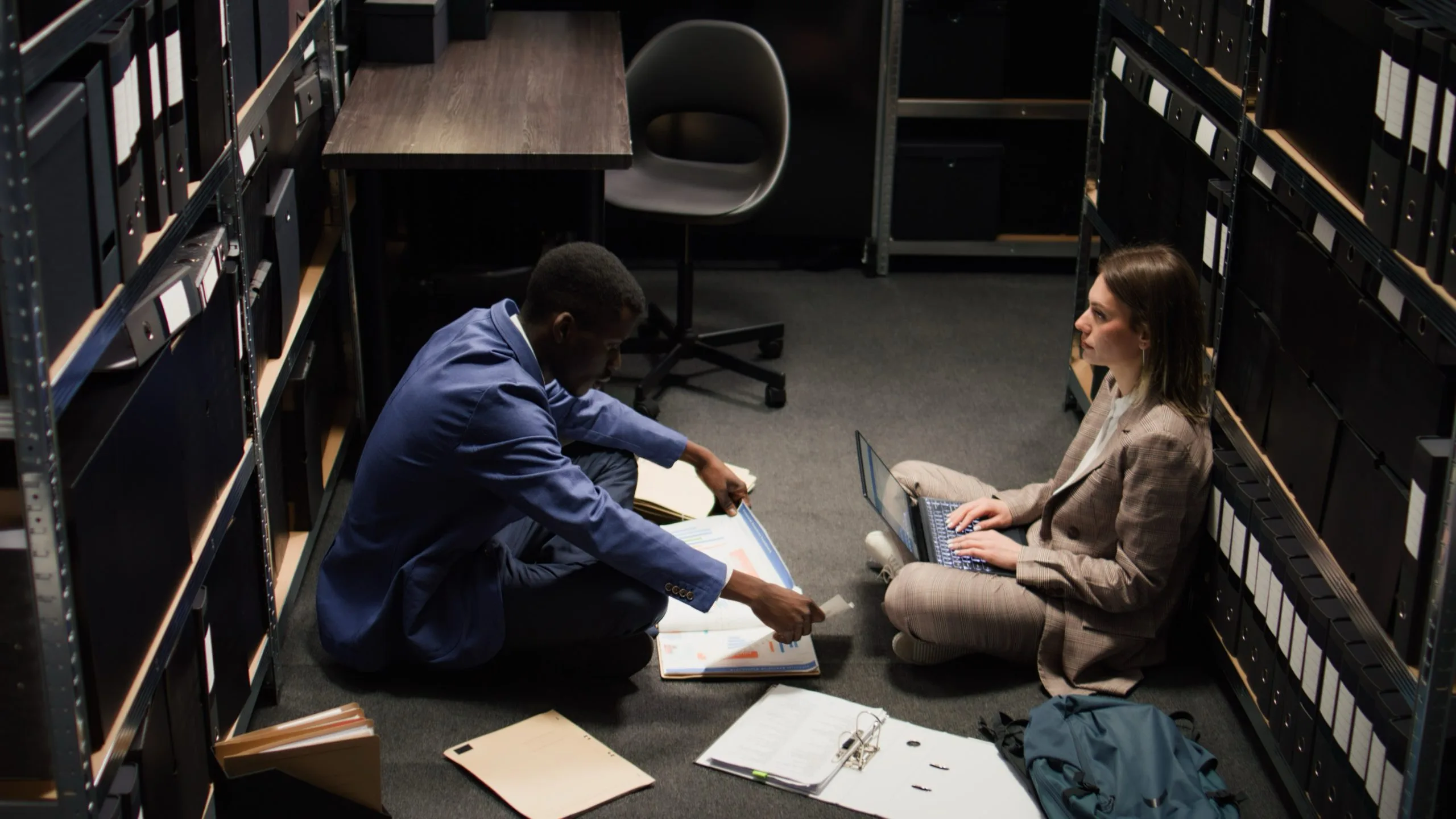 Investigators reviewing case files in an office