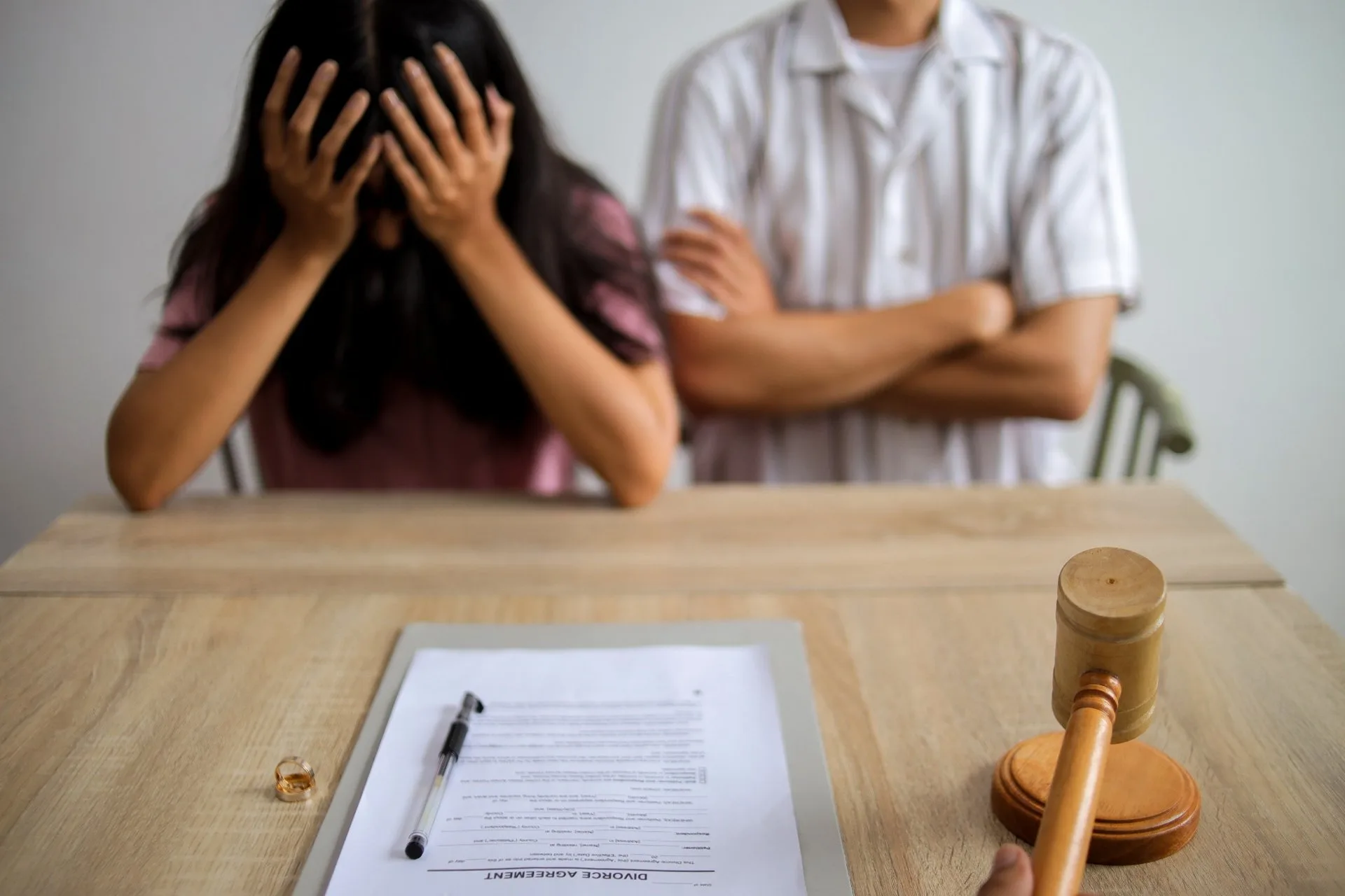 Couple at a table with divorce papers and a gavel